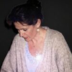 A peaceful woman sitting in quiet reflection, illustrating how to learn meditation online for stress relief and deep nervous system regulation.